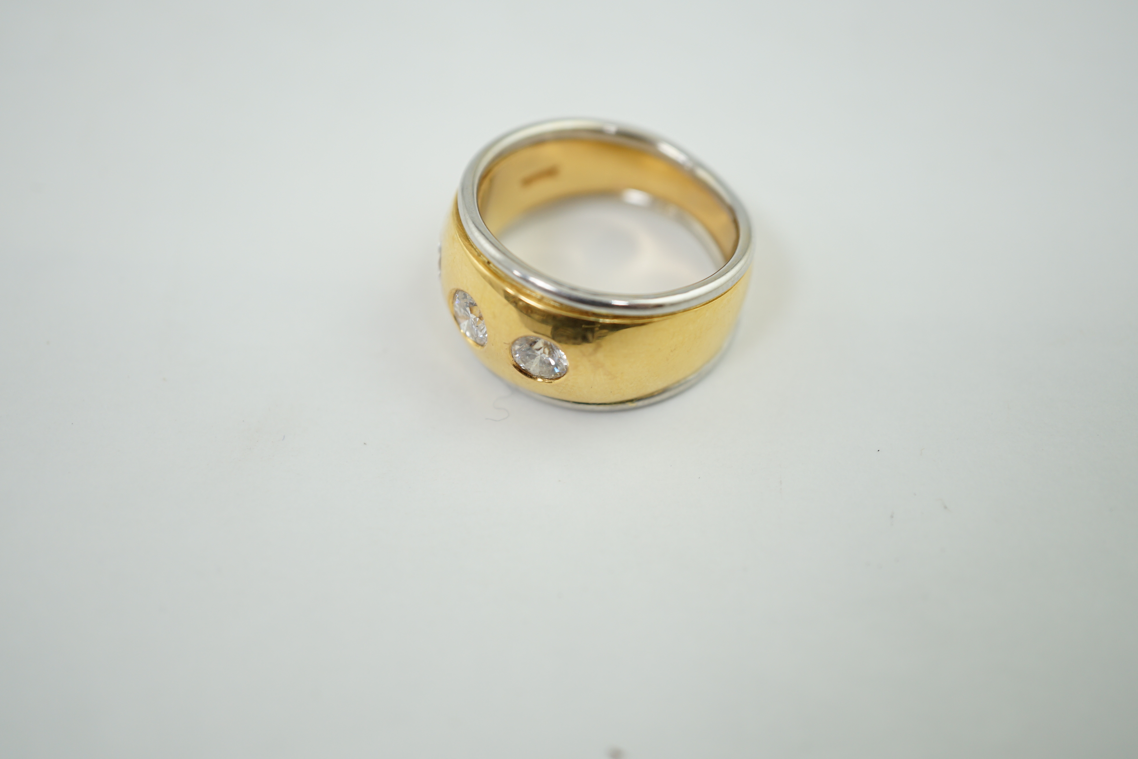 A 22ct gold and platinum gypsy set three stone diamond ring